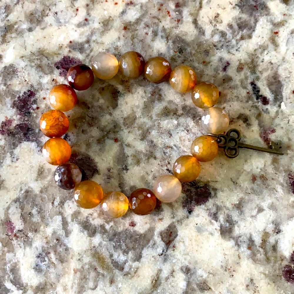 Brown beaded bracelet with key charm